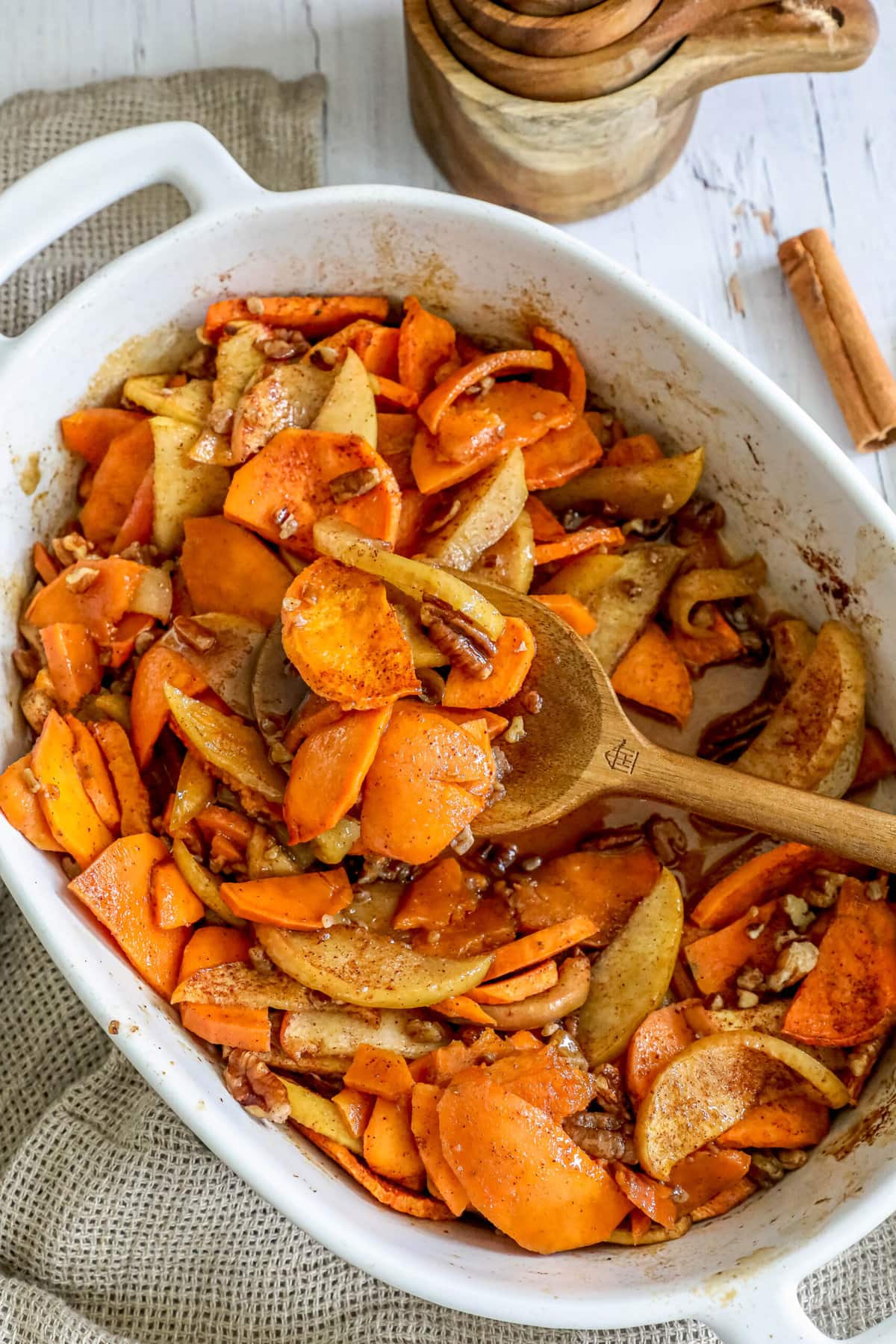 picture of baked sweet potatoes and apples in a dish with cinnamon and nuts