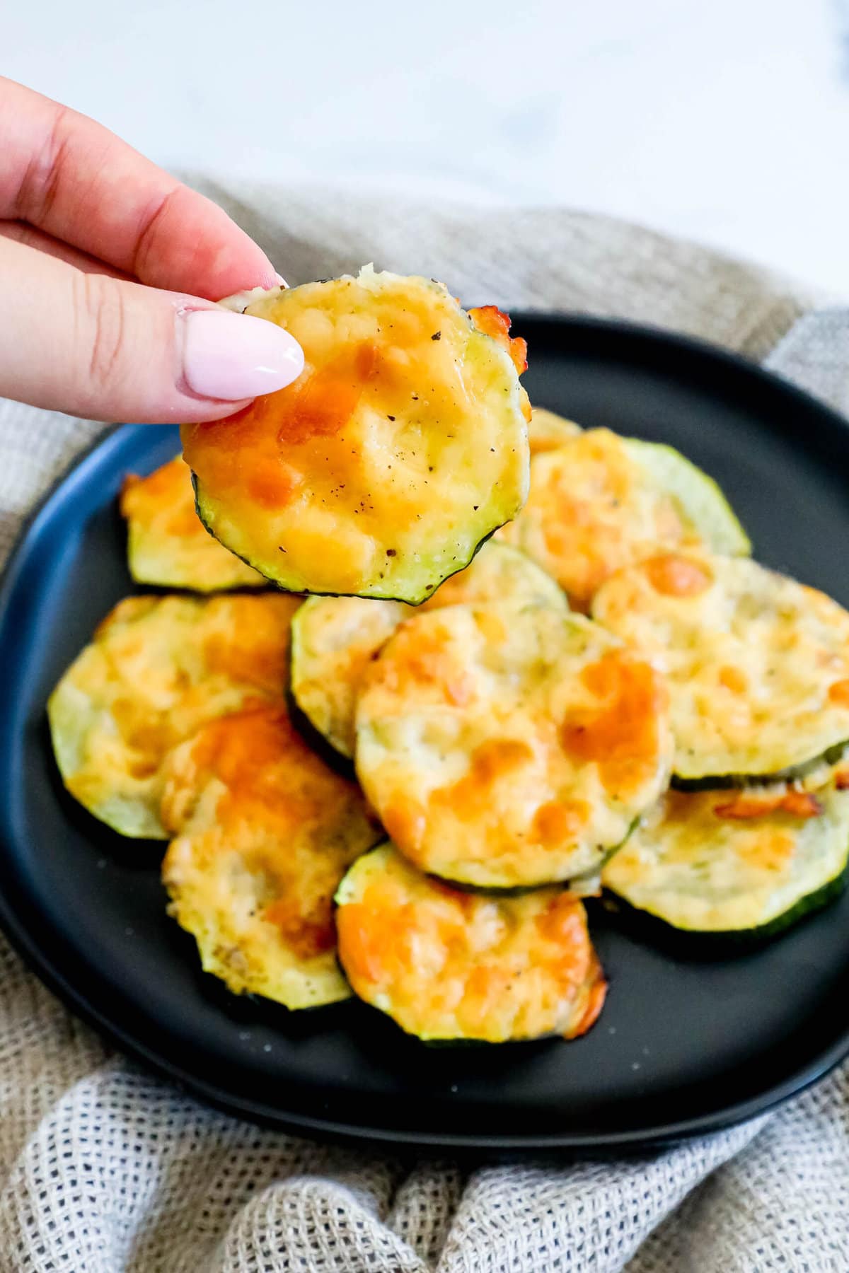 picture of sliced baked zucchini topped with cheese