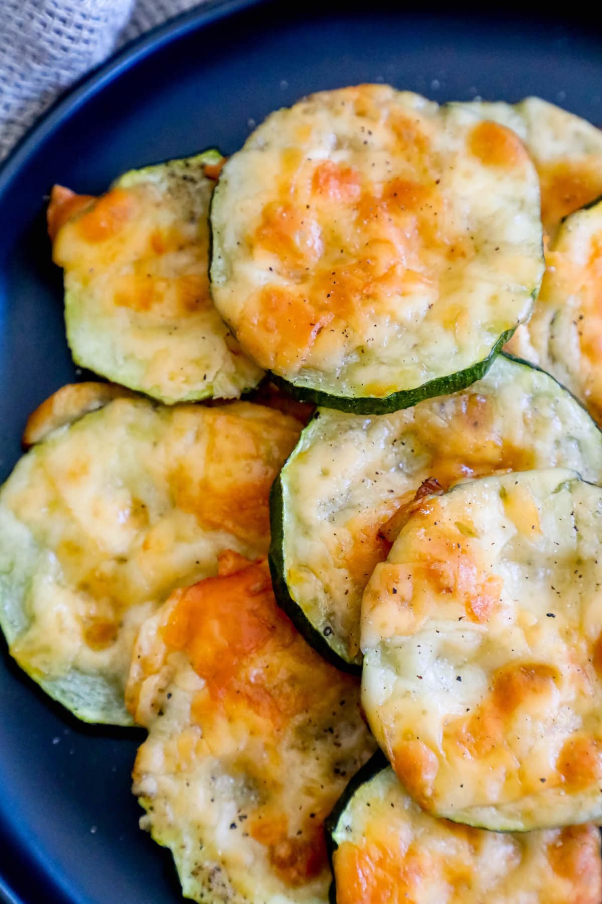 picture of sliced baked zucchini topped with cheese