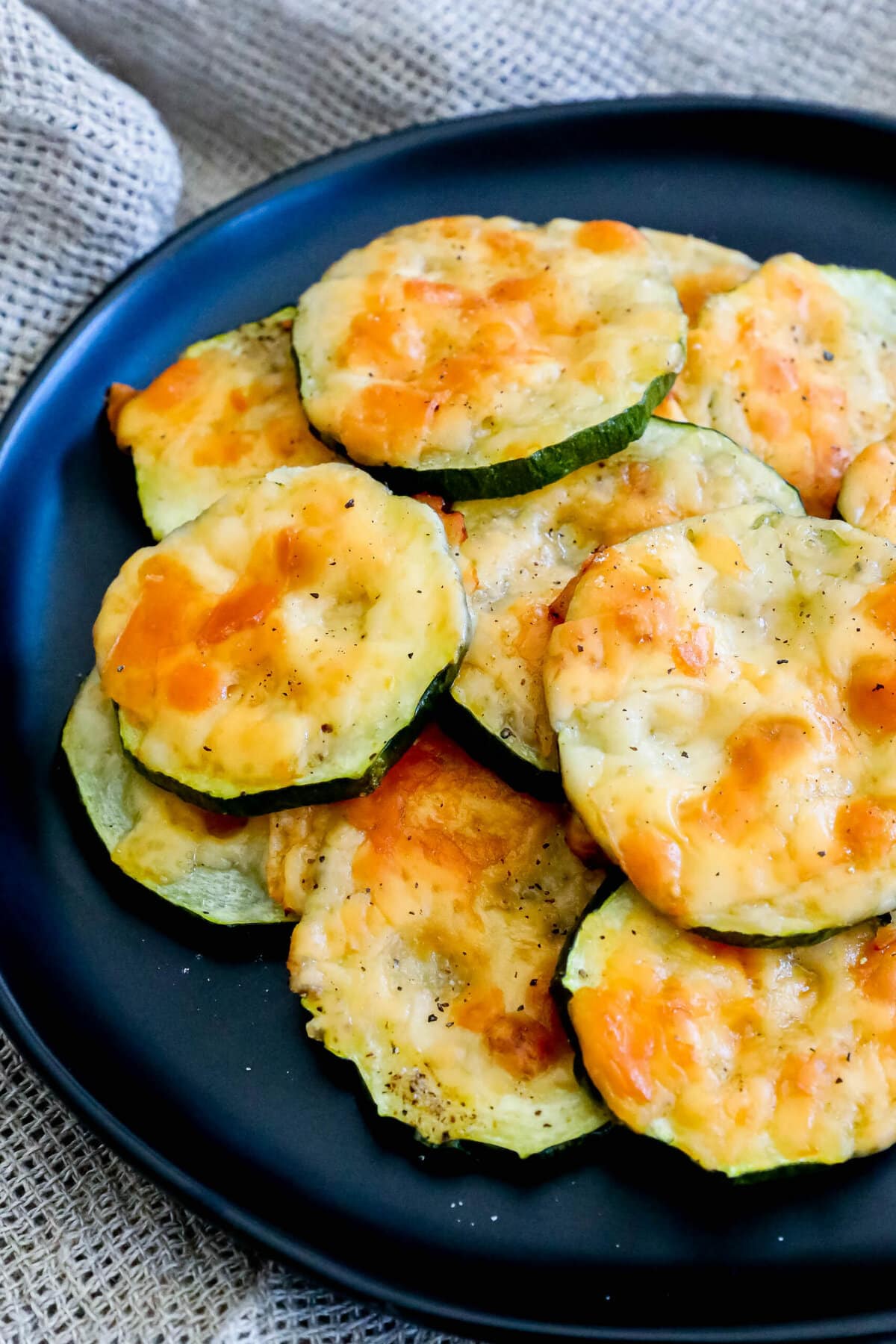 picture of sliced baked zucchini topped with cheese