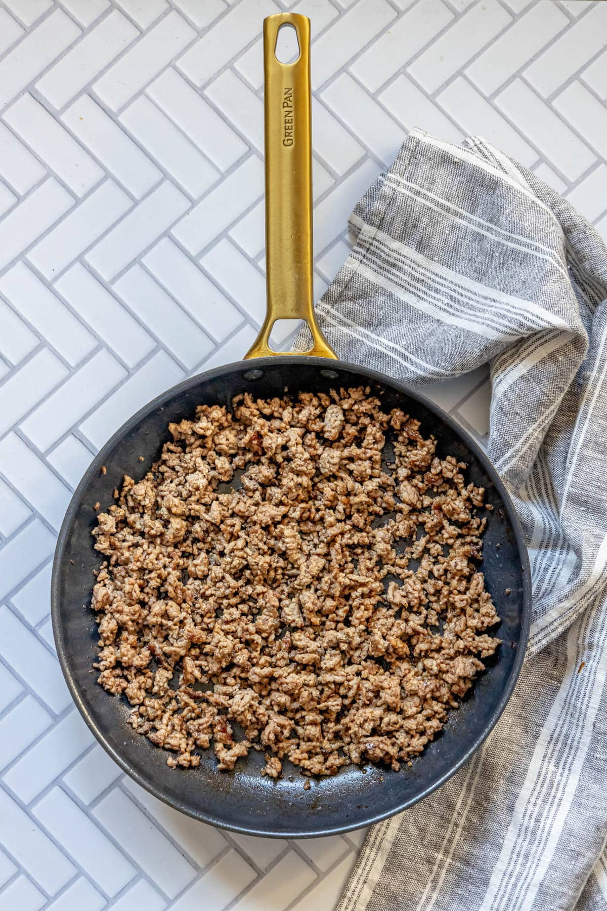 A cheeseburger stuffing recipe made with ground beef in a frying pan.