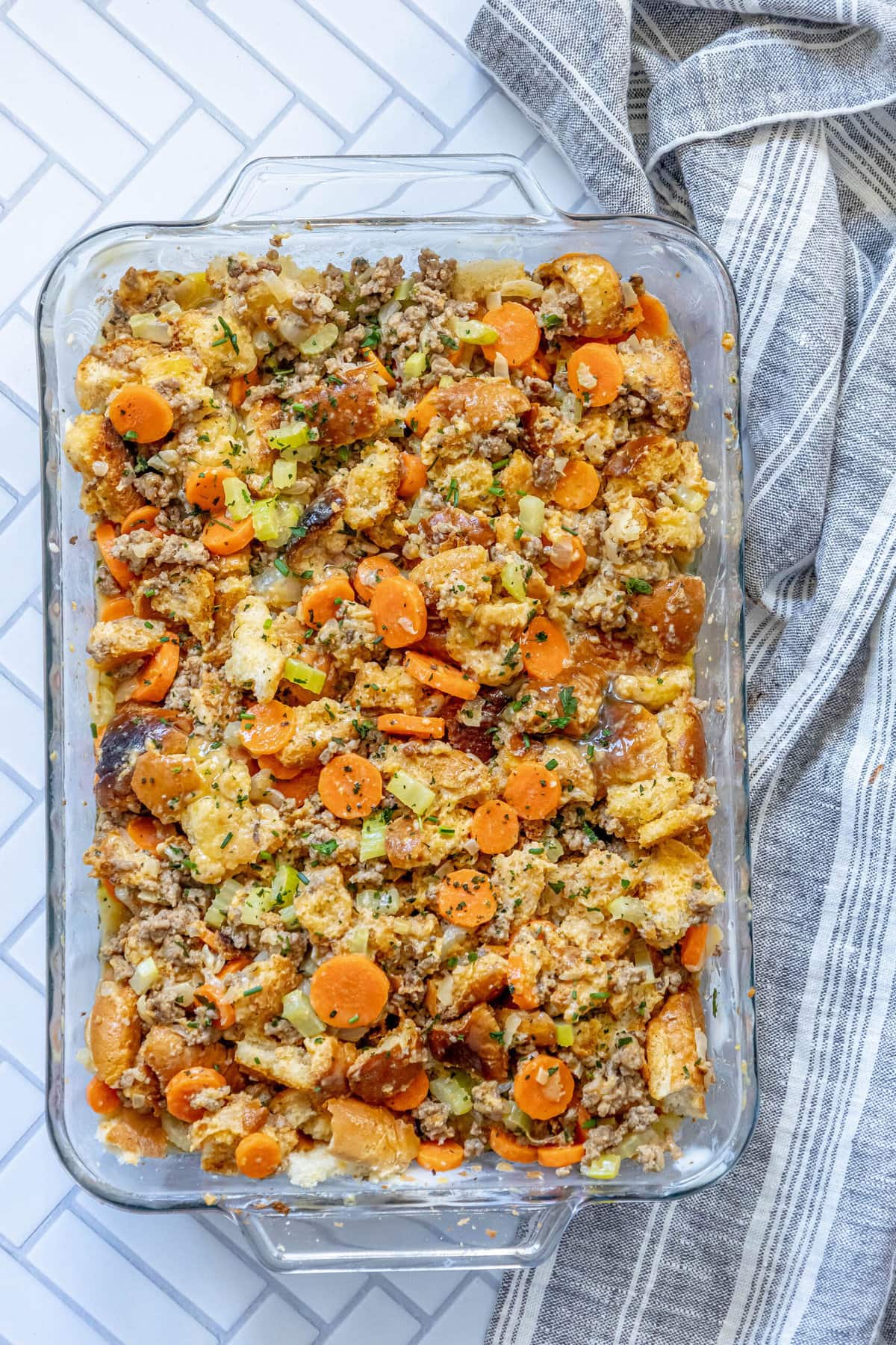 A casserole dish filled with cheeseburger stuffing and carrots.