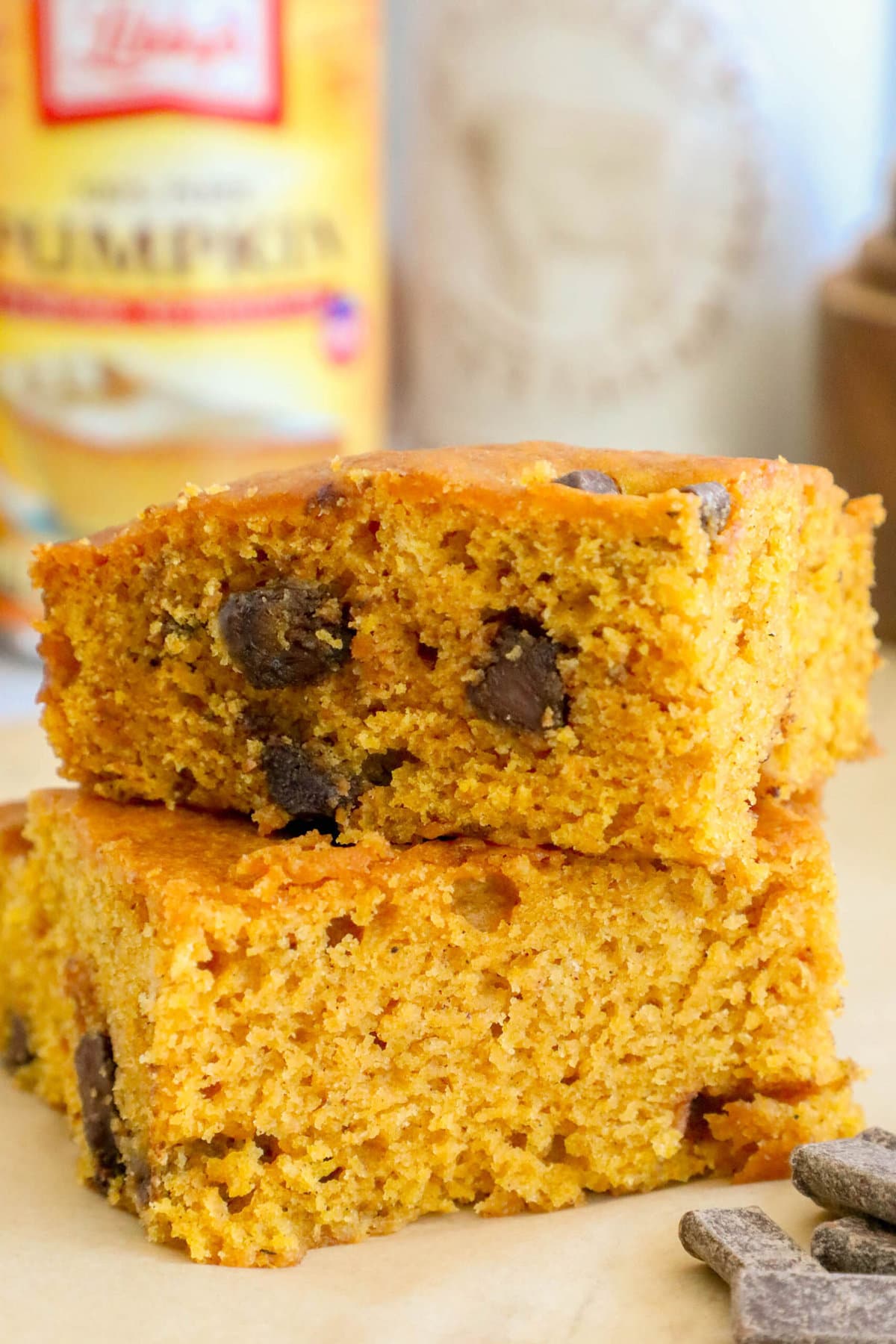 picture of baked pumpkin bars with chocolate chunks stacked on top of each other on a table