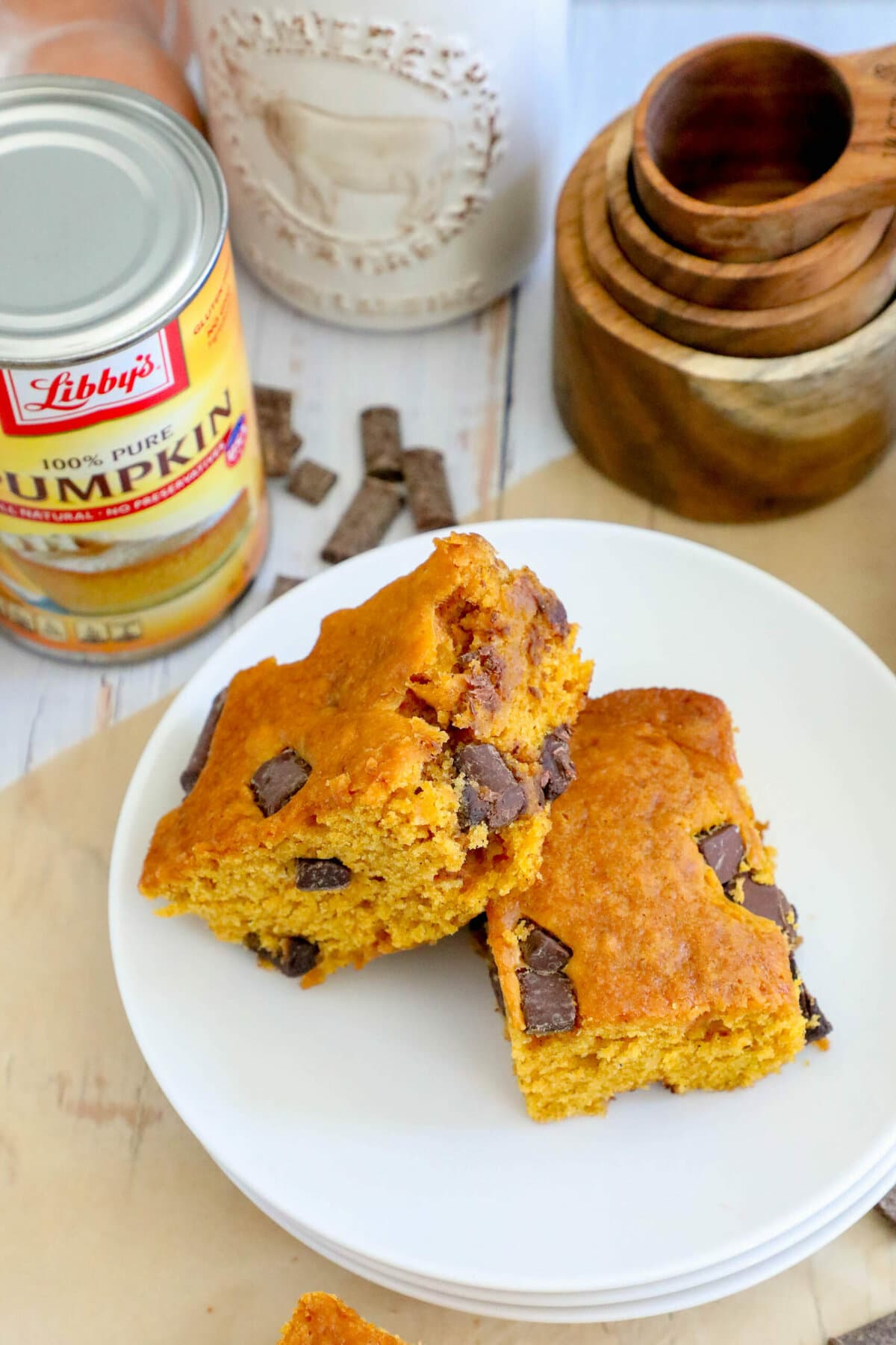 picture of baked pumpkin bars with chocolate chunks stacked on top of each other on a table