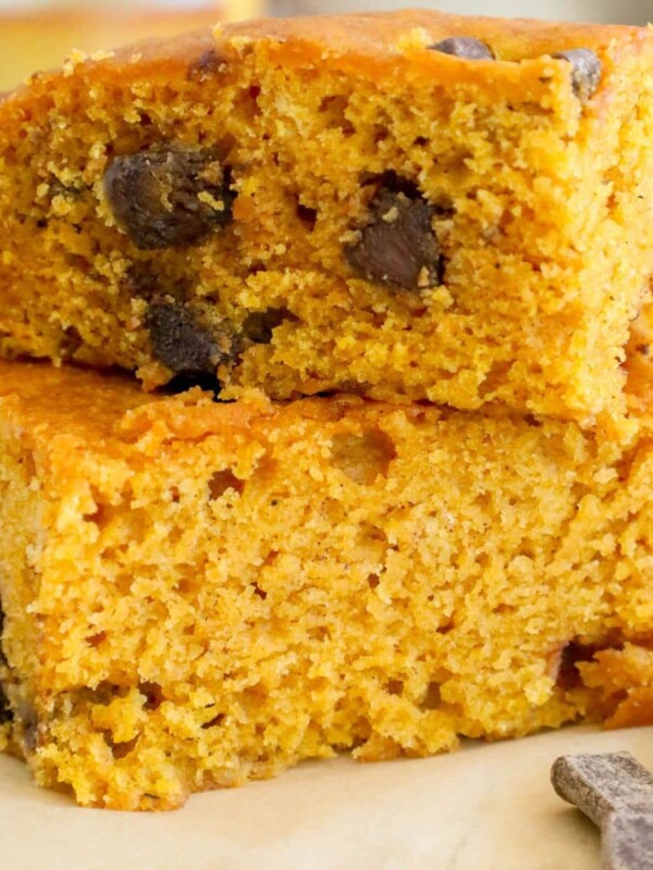 picture of baked pumpkin bars with chocolate chunks stacked on top of each other on a table