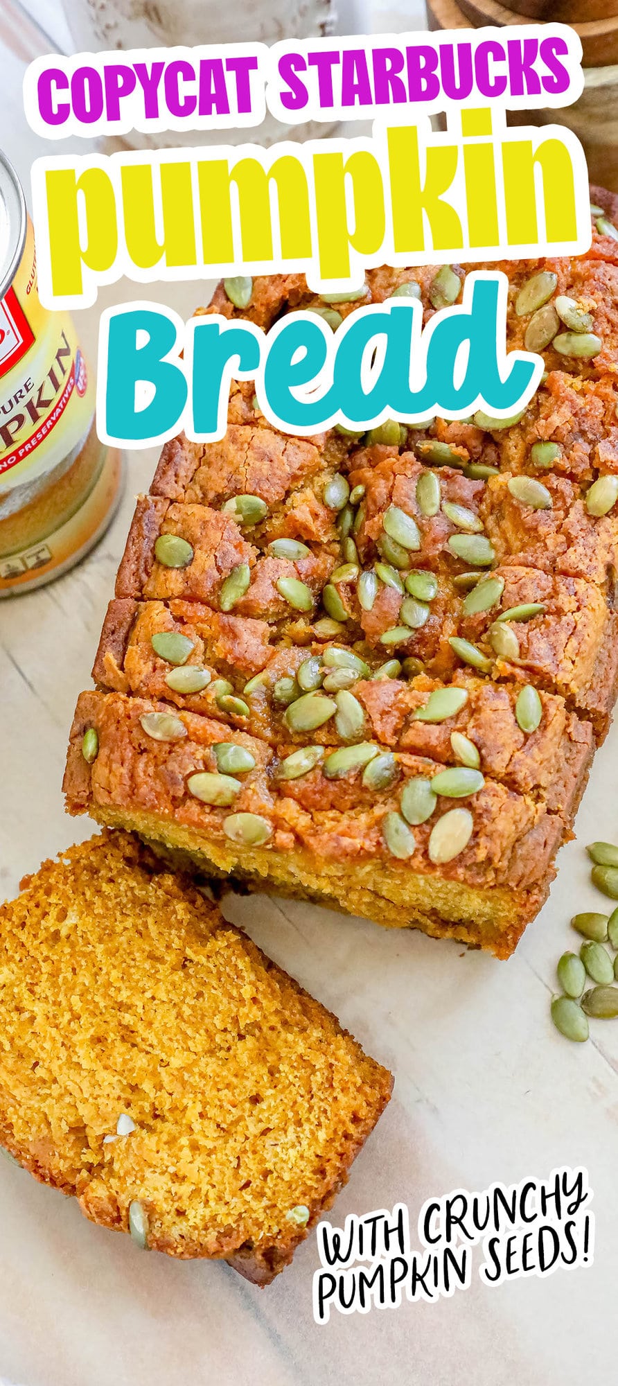 pumpkin bread with pumpkin seeds baked onto the top sliced on a table