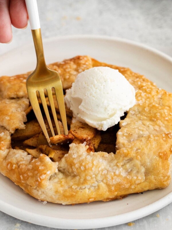 A homemade apple galette served with a scoop of ice cream.