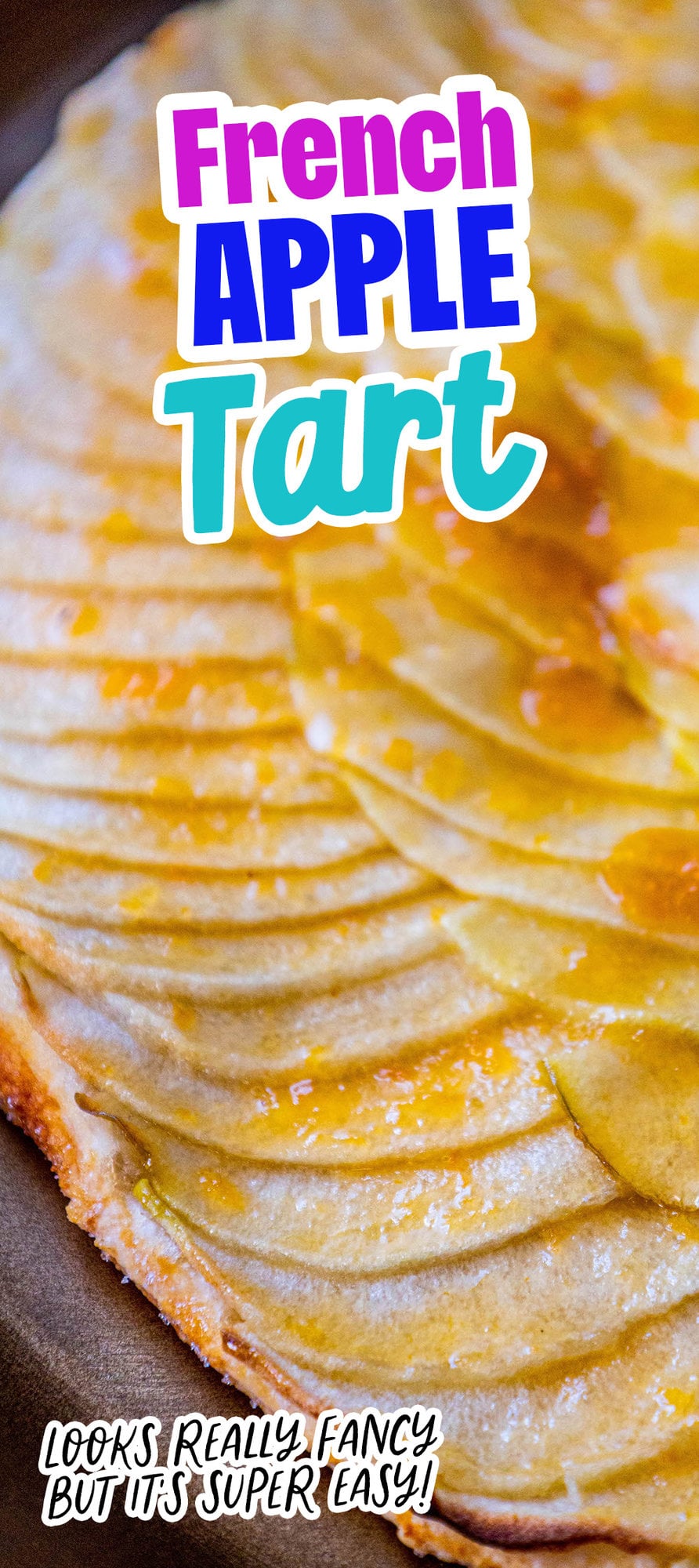 picture of a baked apple tart with thinly sliced apples baked in a circle and glazed with apricot glaze on a gold plate