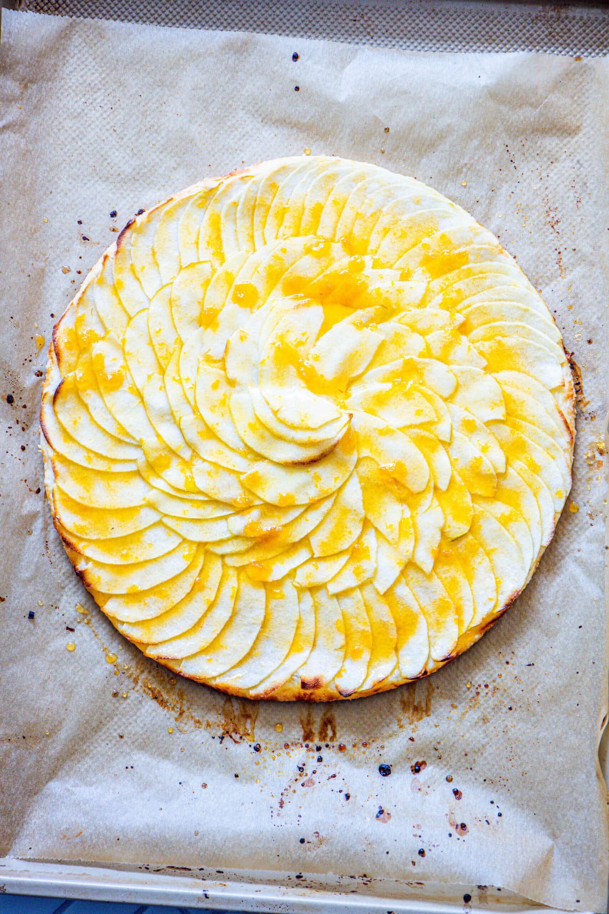 A pizza on a baking Easy French Apple Tarts.