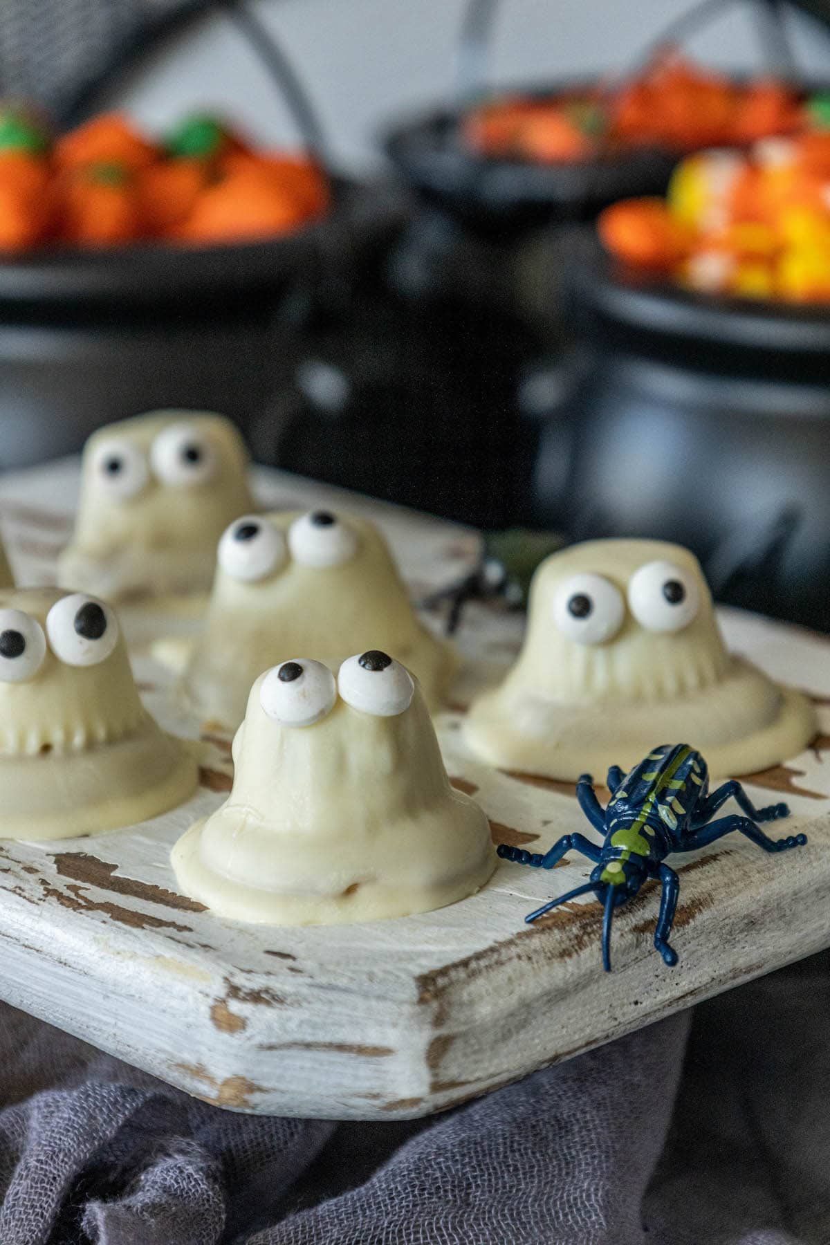 picture of cookies dipped in white chocolate with candy eyes to look like ghosts