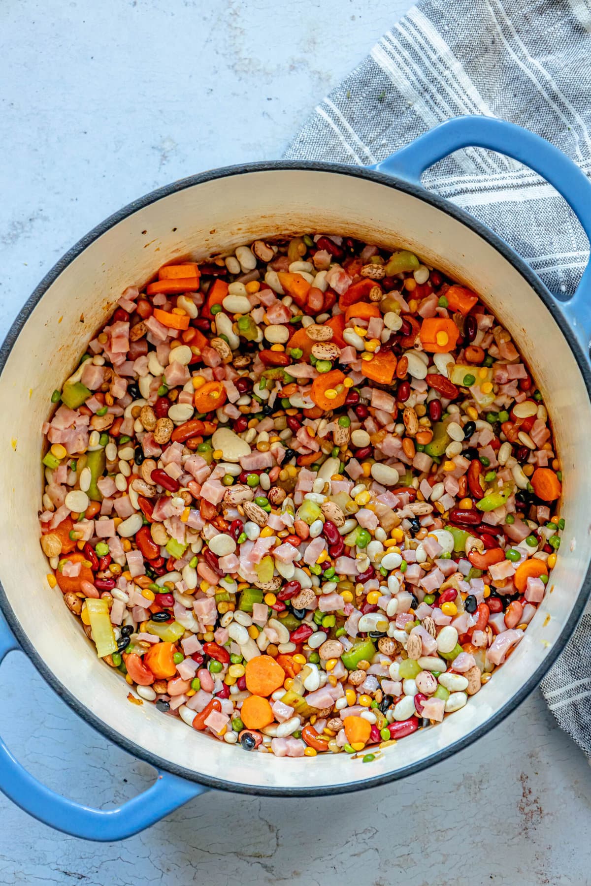 picture of beans in dutch oven with browned vegetables