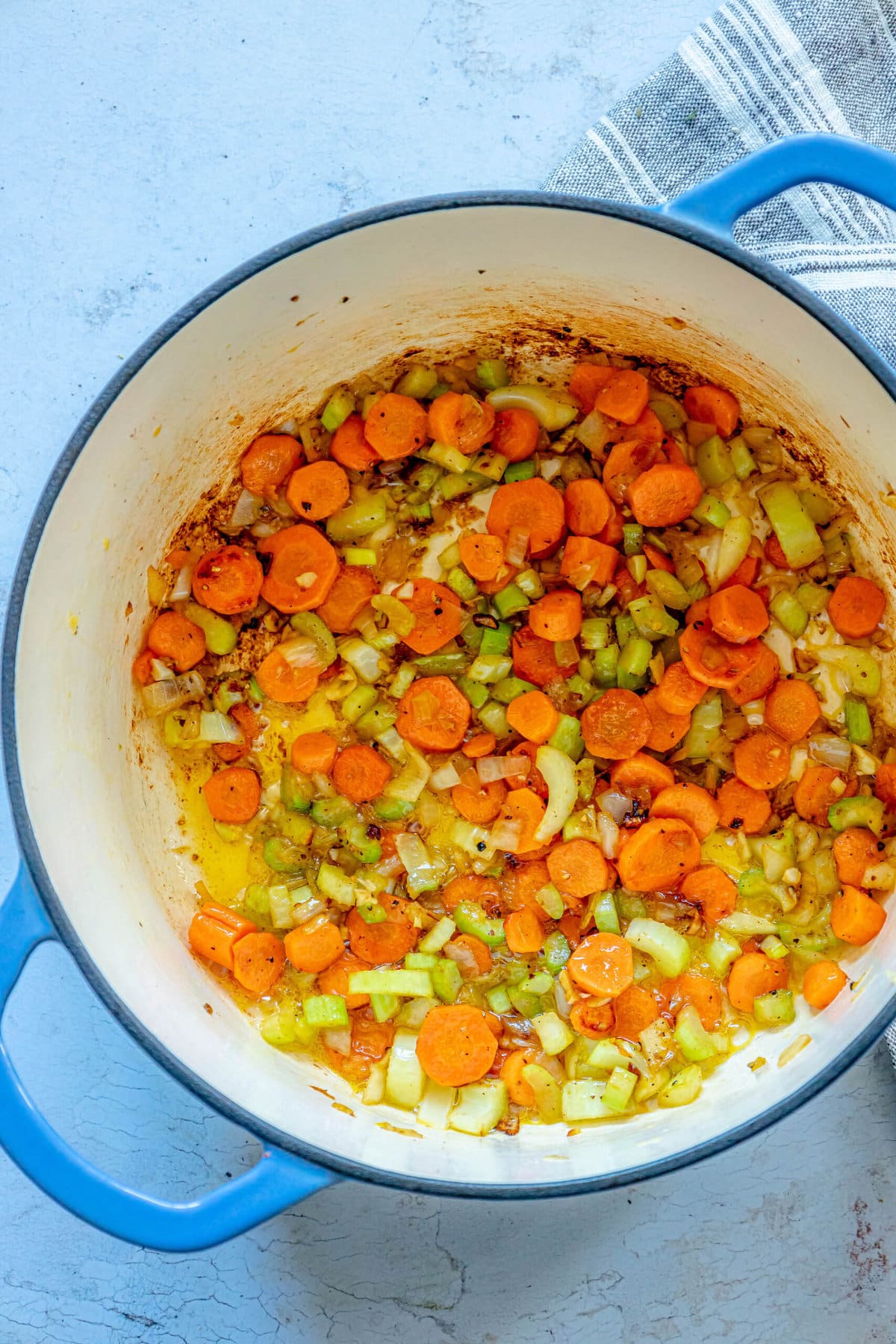 picture of browned carrots, celery, garlic, and onions in a dutch oven
