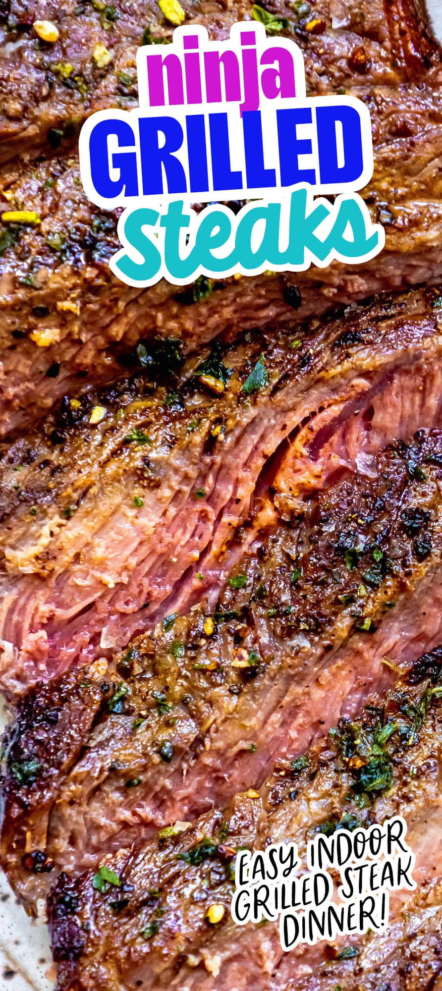 picture of a grilled steak sliced into strips and seasoned with salt, pepper, and herbs on a plate