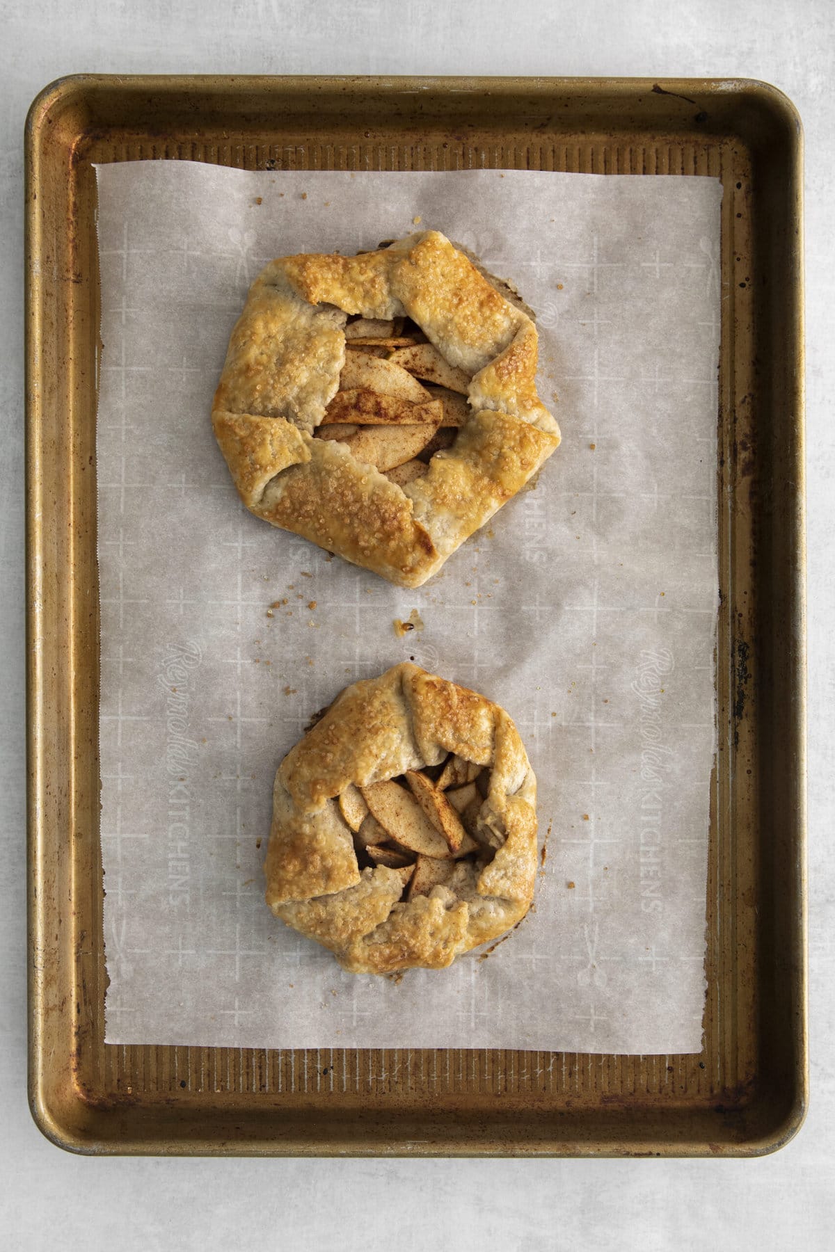 picture of apple galette on a baking sheet lined with parchment paper