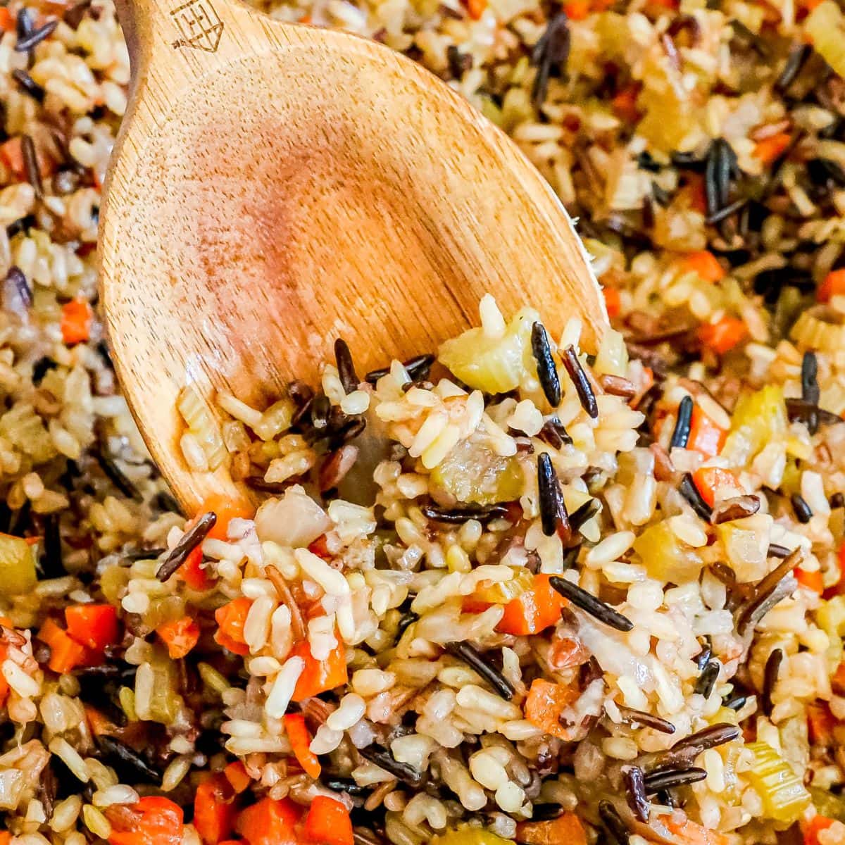 picture of wooden spoon in wild rice pilaf