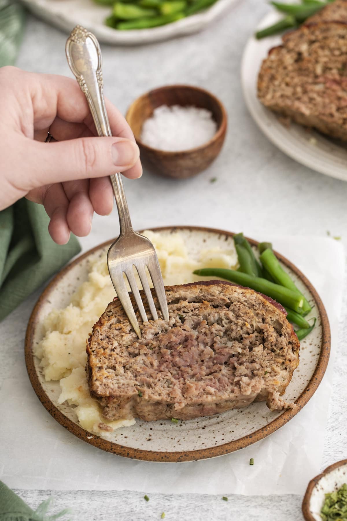 fork in meatloaf with green beans