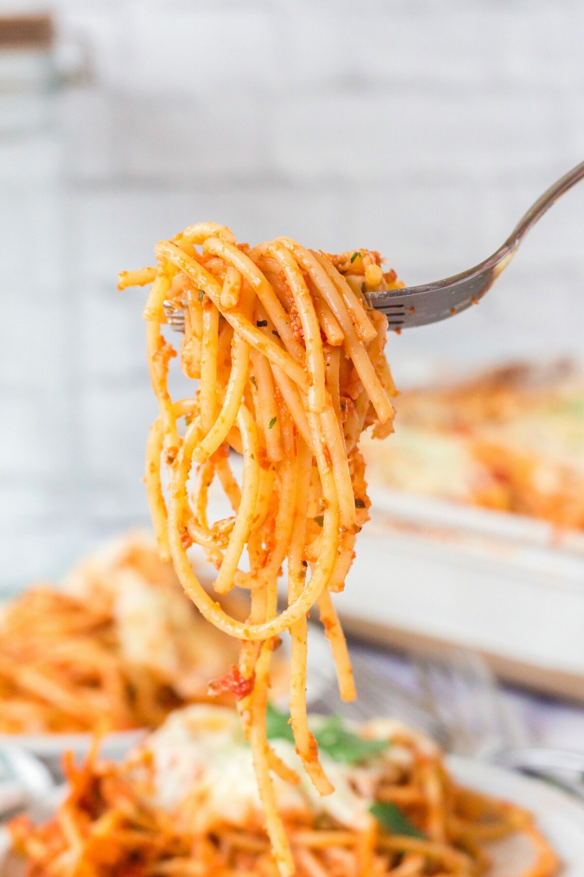 picture of baked spaghetti with melted cheese on a fork