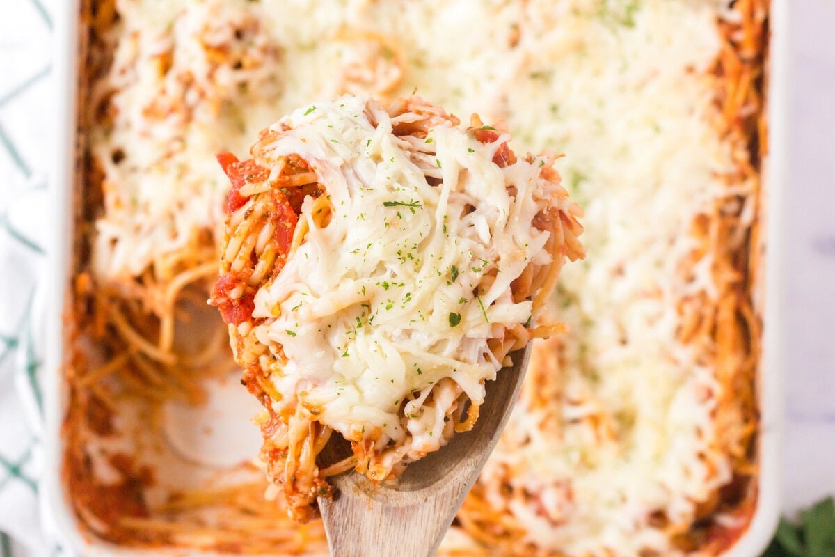 picture of baked spaghetti on a spoon with melted cheese 