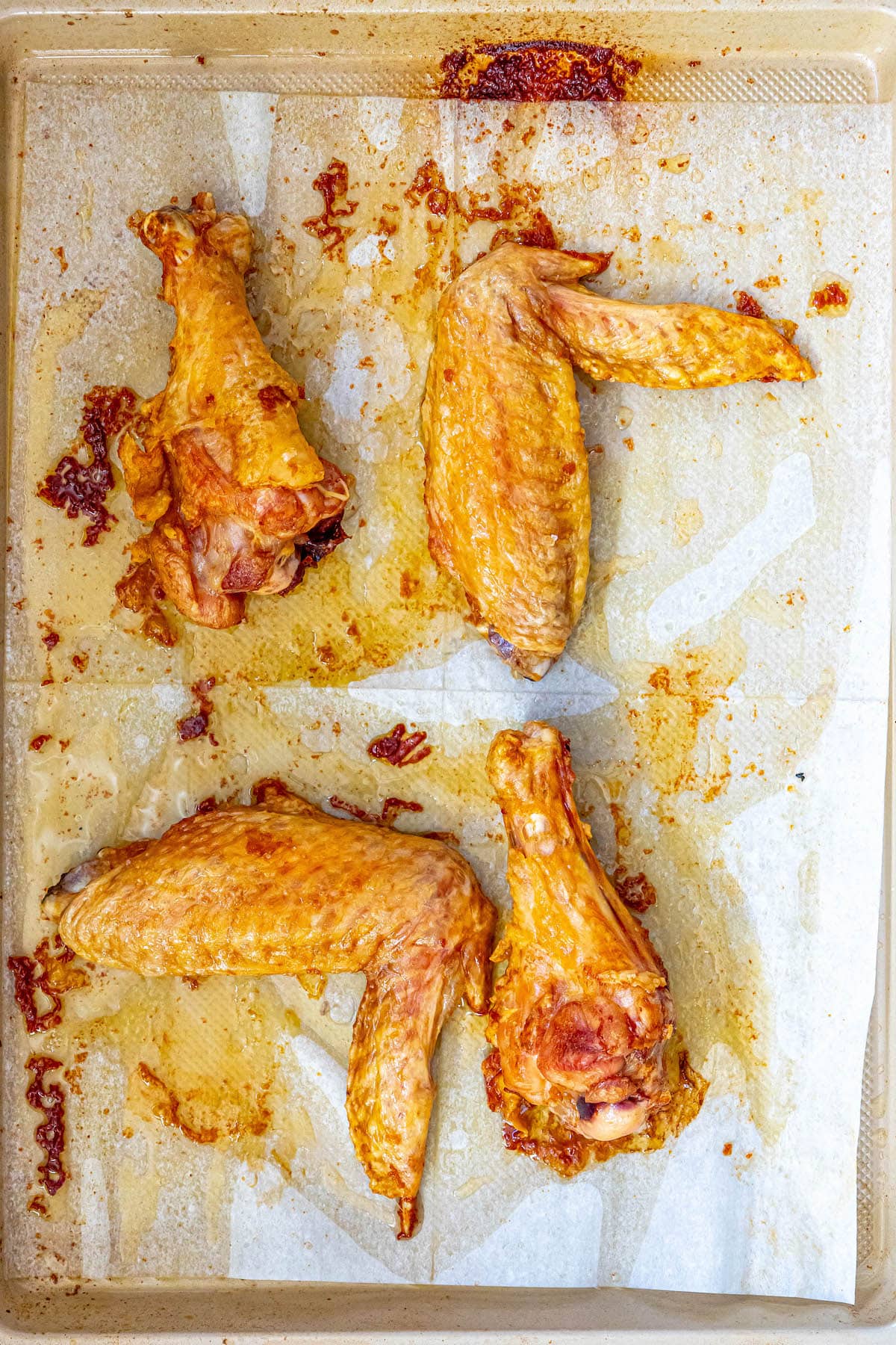 roasted turkey wing pieces on a baking sheet lined with parchment paper