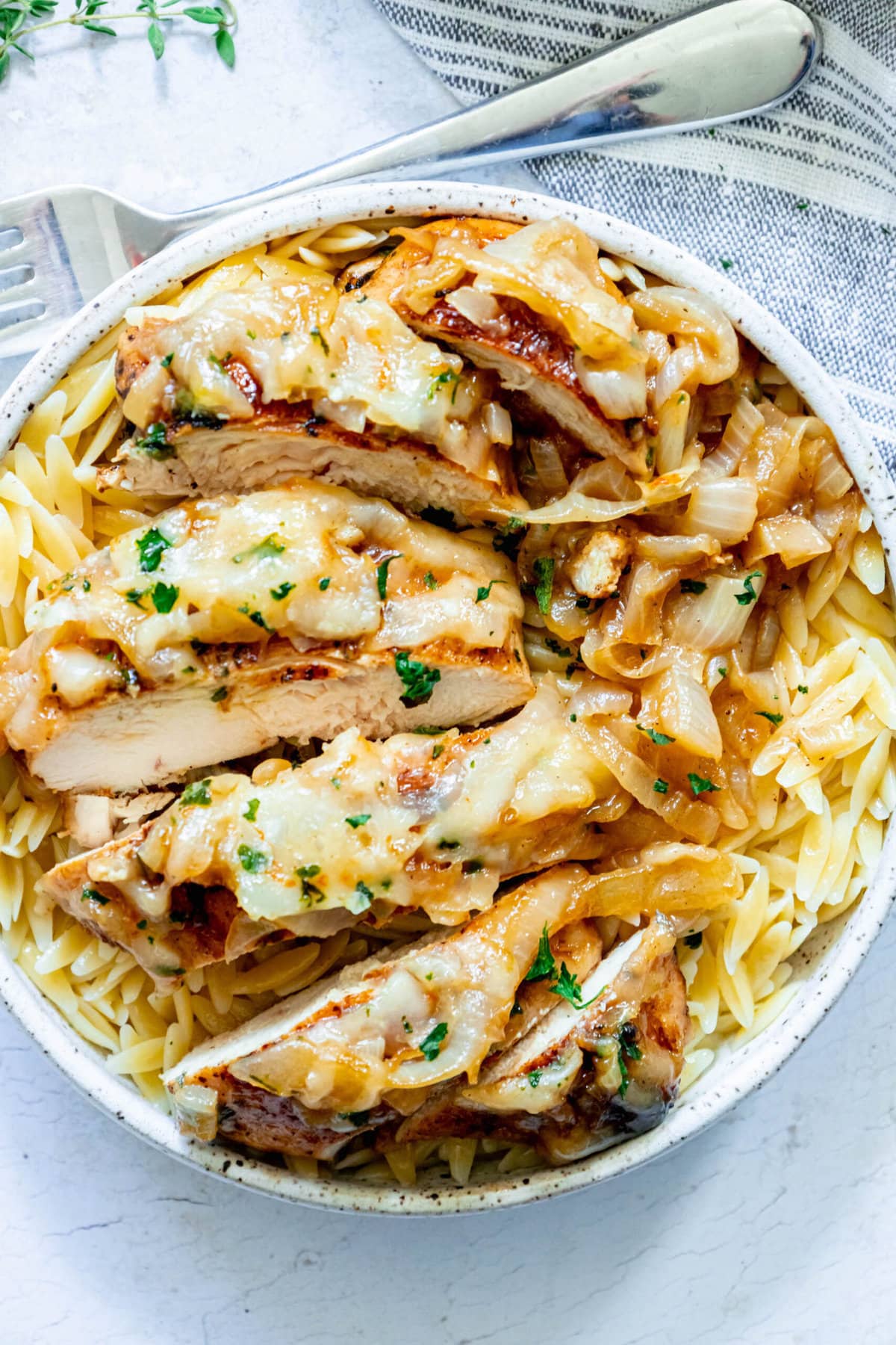picture of chicken breast with melted cheese and browned french onions
