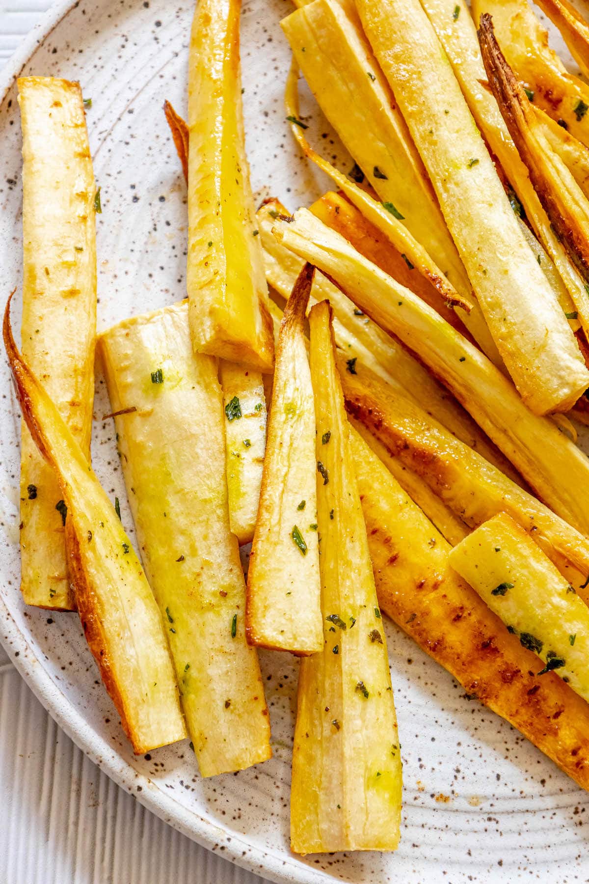roasted parsnips seasoned with garlic butter and herbs with salt and pepper