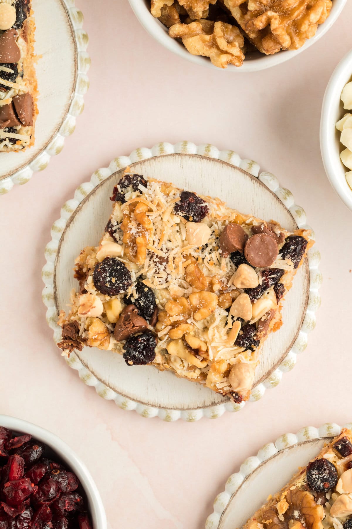 picture of sliced cranberry cookie bars with chocolate chips white chocolate, nuts, and butterscotch on a table