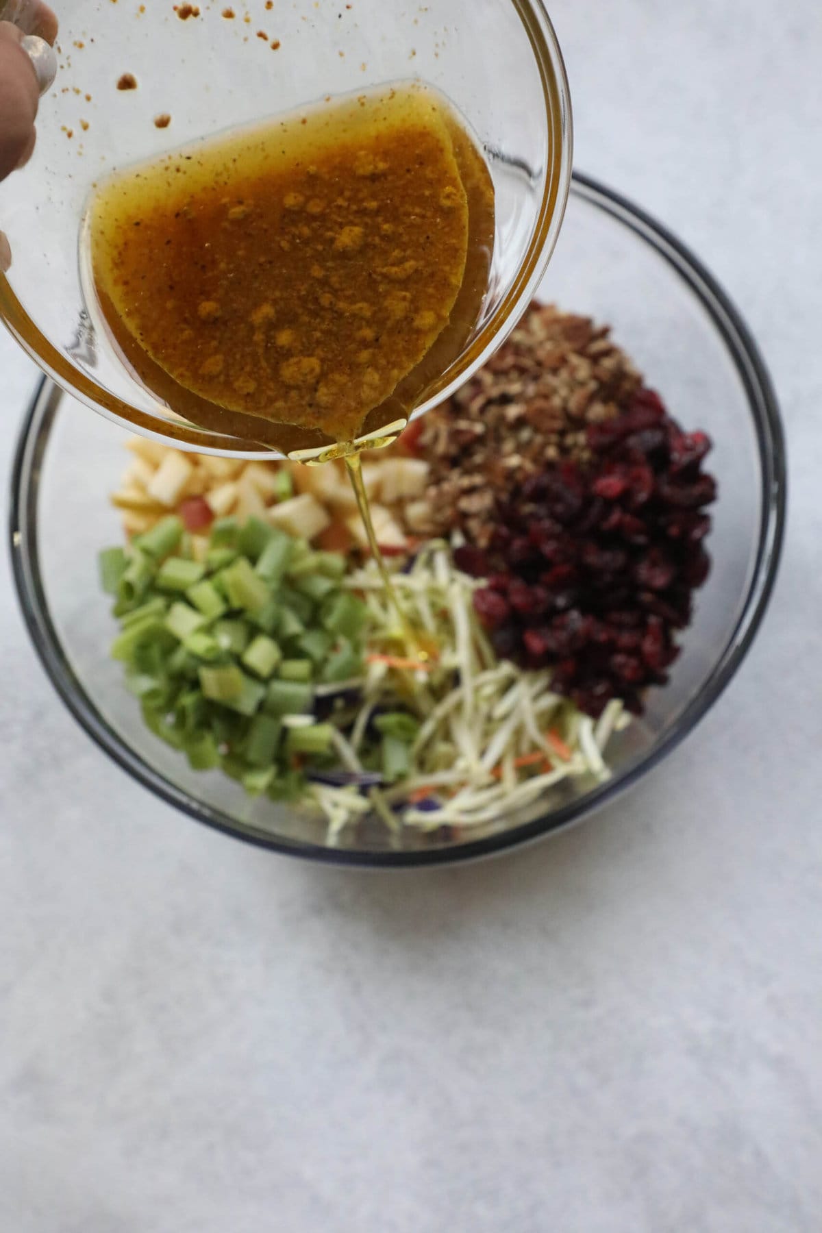 Harvest Cranberry Pecan Salad 5 Picture of vinaigrette being poured into cranberry slaw salad