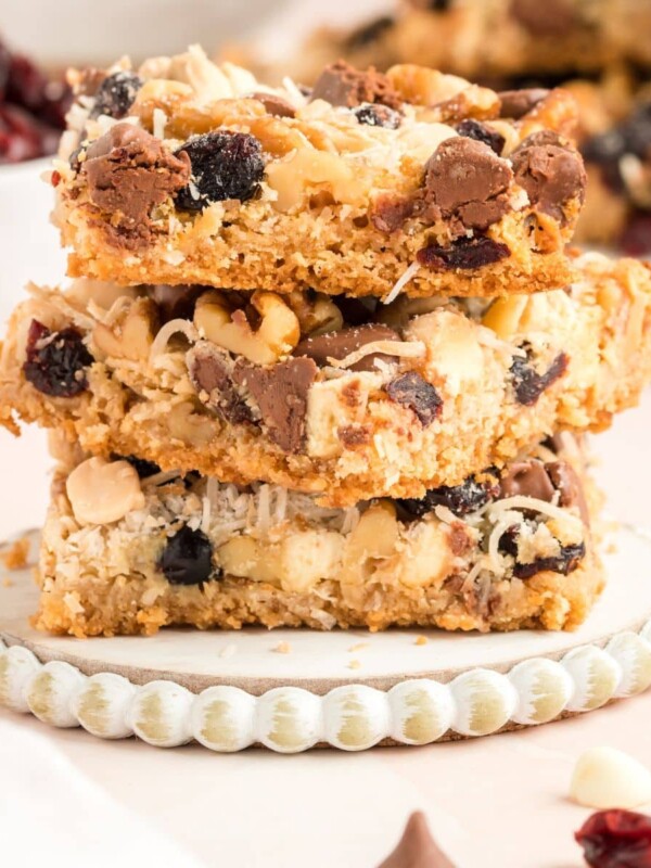 picture of sliced cranberry cookie bars with chocolate chips white chocolate, nuts, and butterscotch on a table