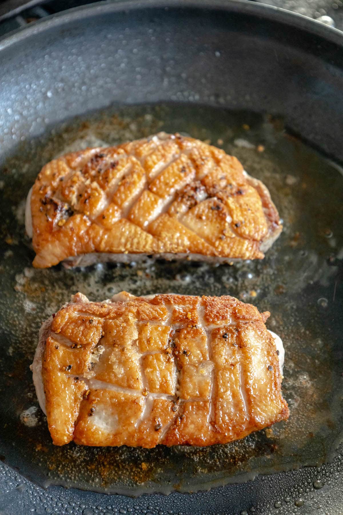 duck searing in a pan