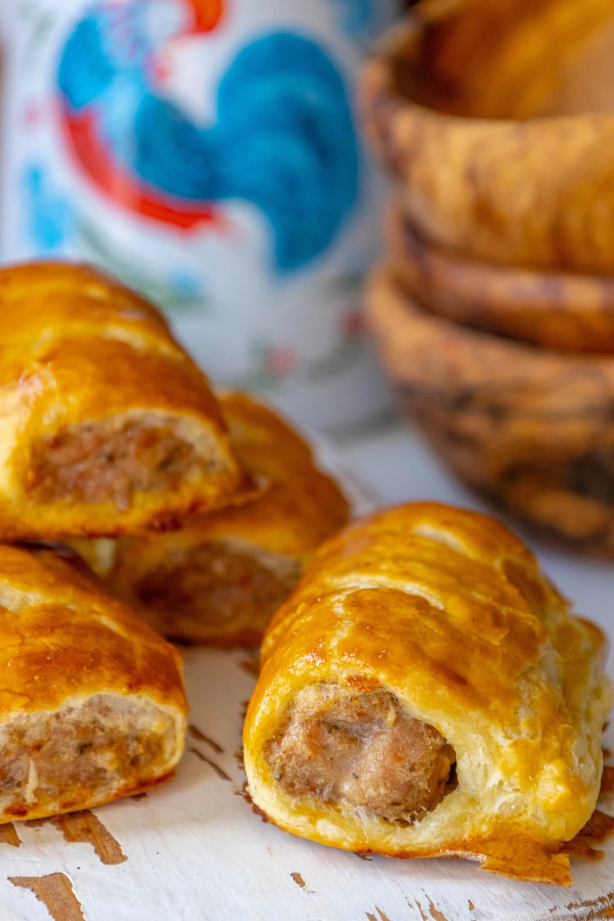 sausage rolls up close on a white cutting board