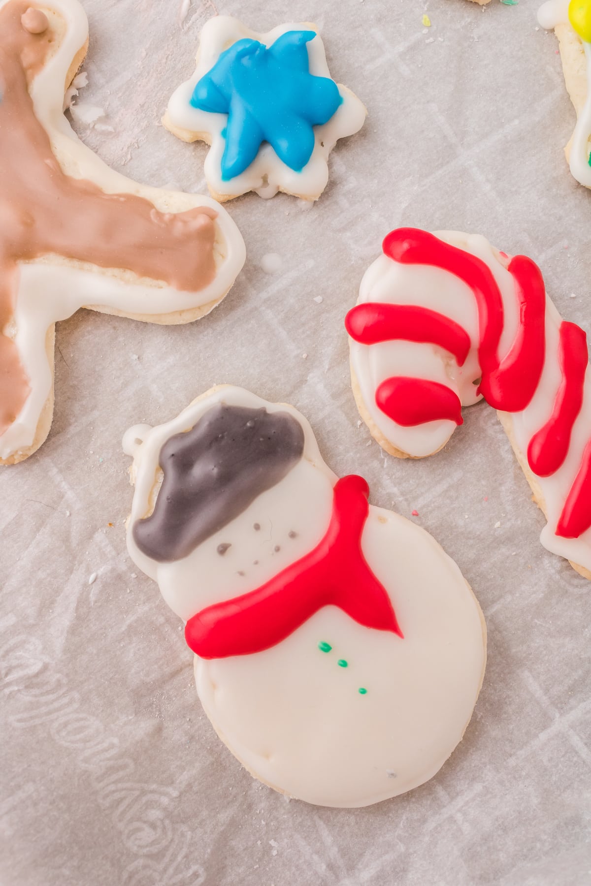 picture of iced christmas cookies on a white plate on a table