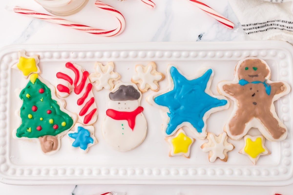 picture of iced christmas cookies on a white plate on a table