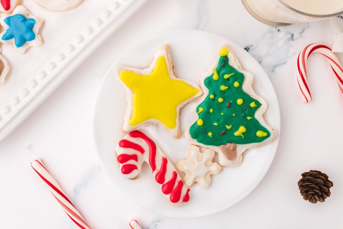 picture of iced christmas cookies on a white plate on a table