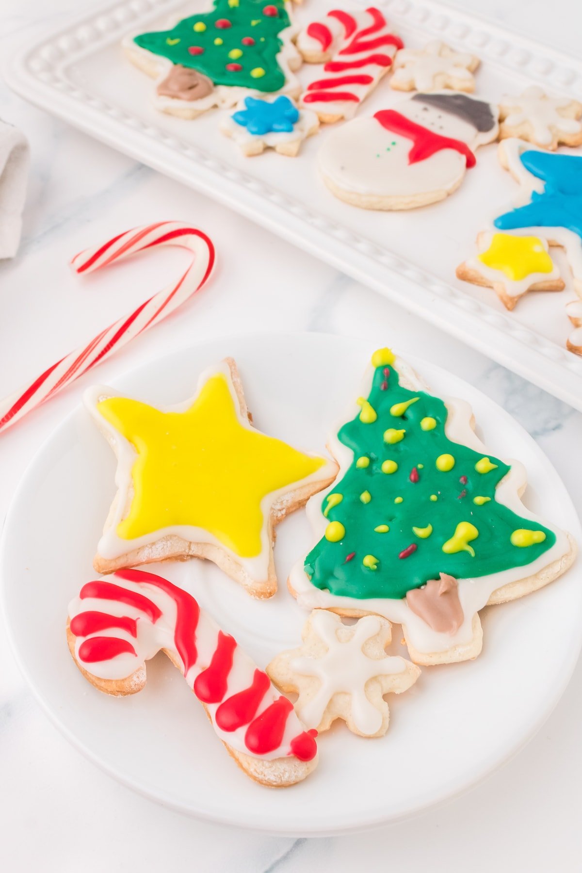 picture of iced christmas cookies on a white plate on a table