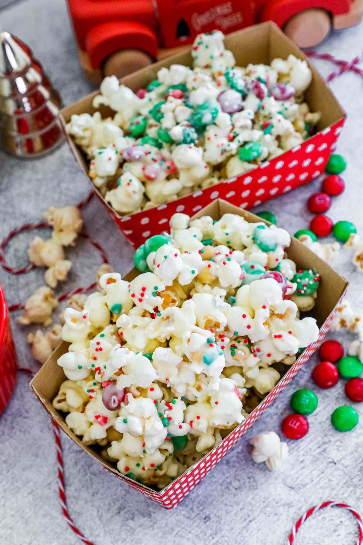 chocolate sprinkle popcorn with candies in a striped box.