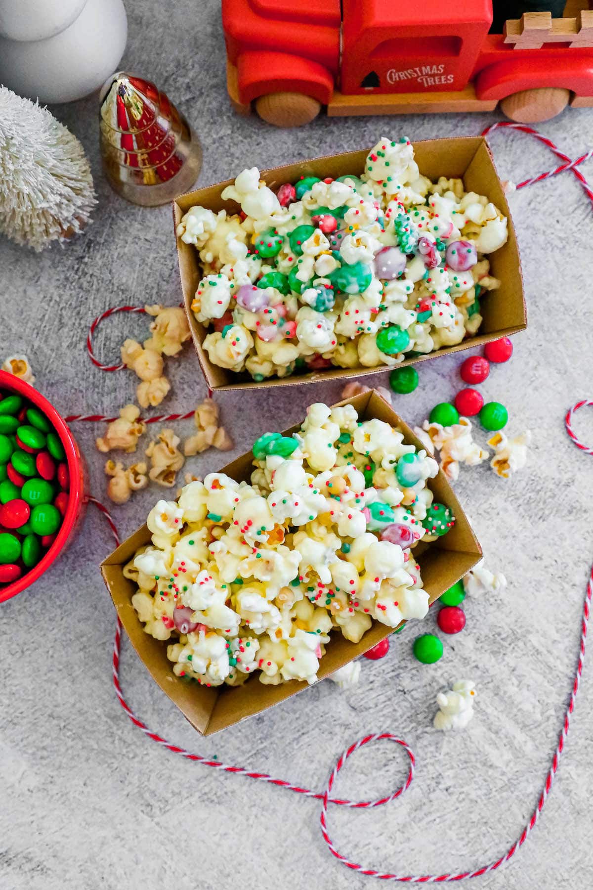 two boxes of popcorn with chocolate and sprinkles on the countertop.