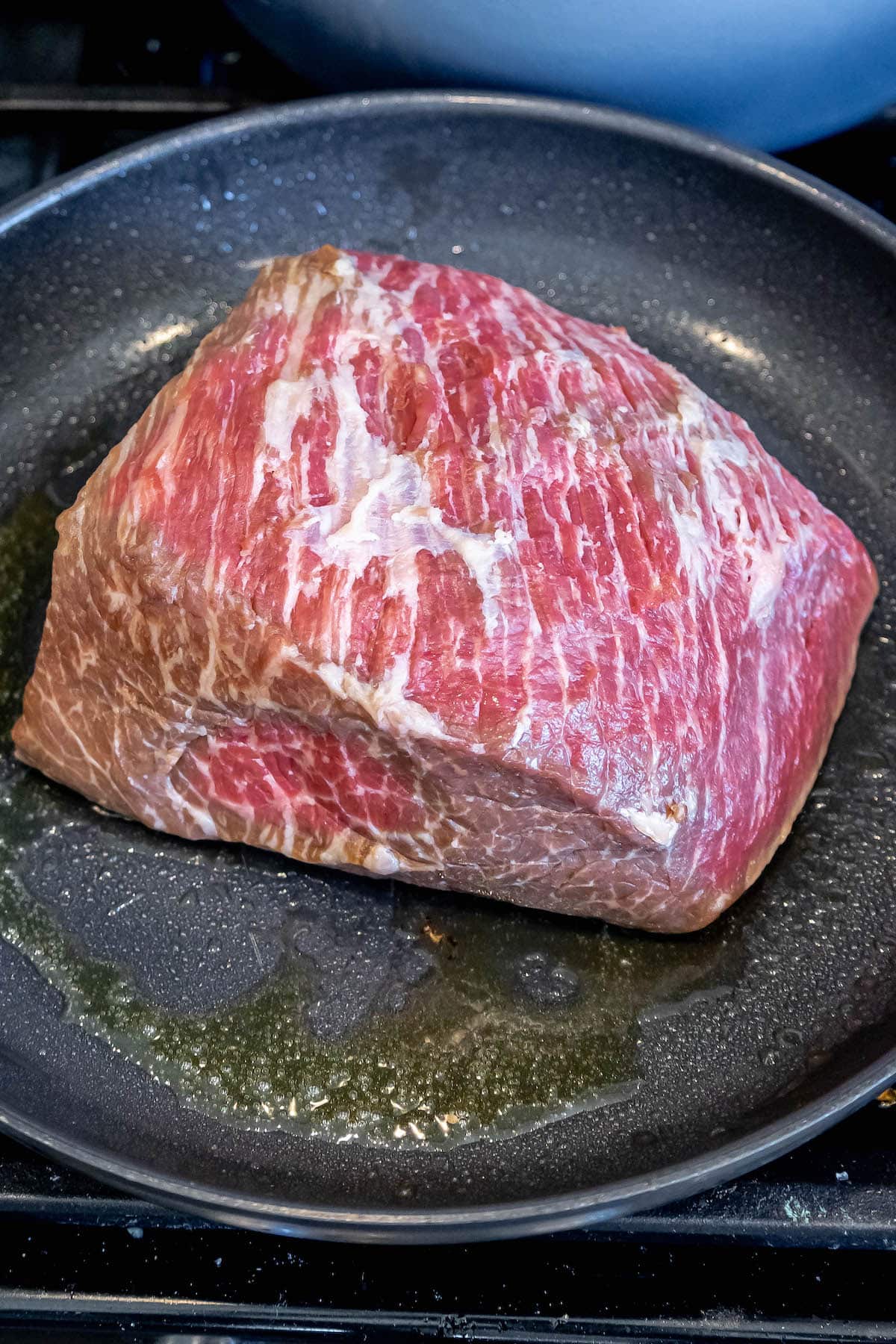 beef roast searing in a pan