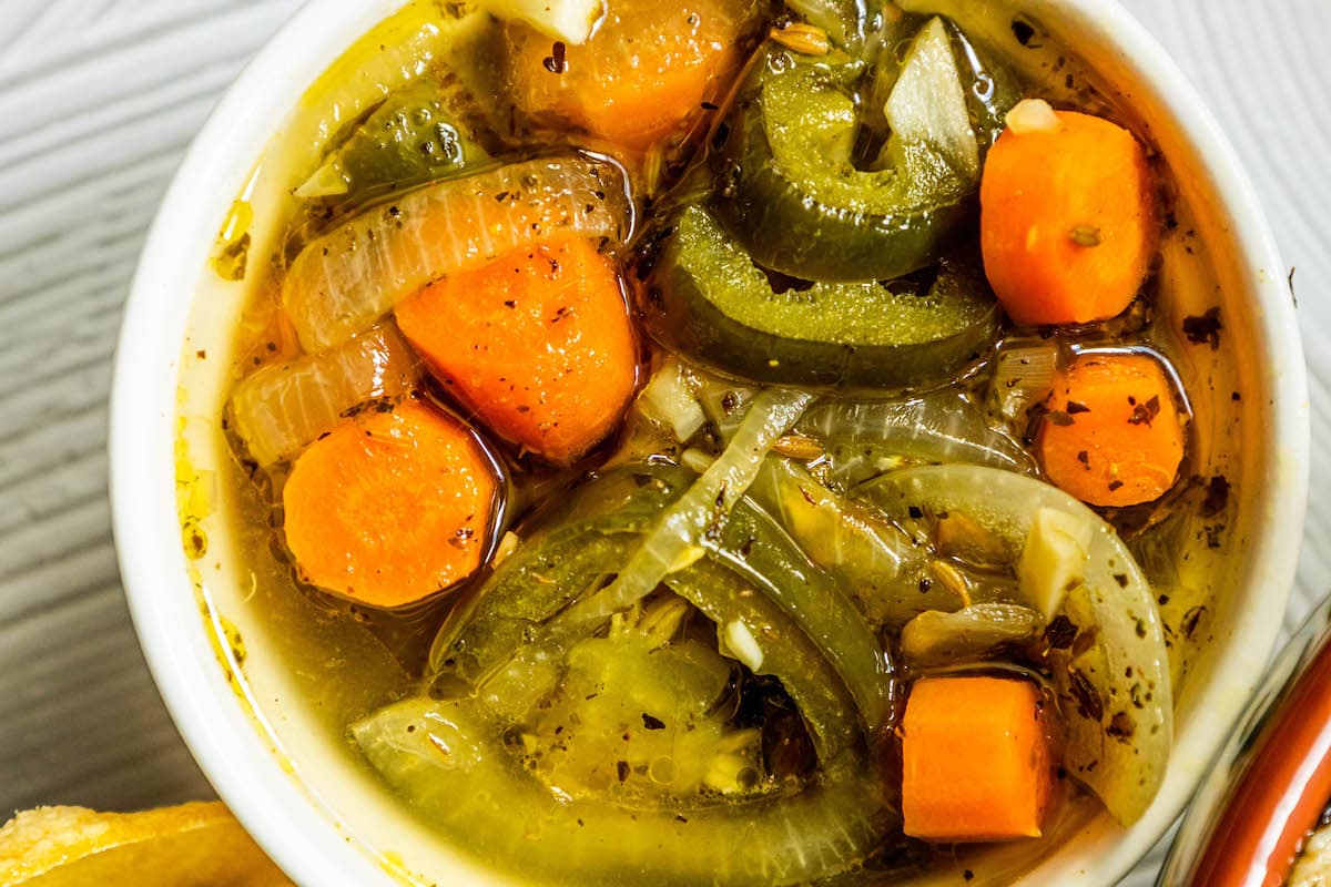 pickled sliced carrots, jalapenos, onions, and spices in a bowl