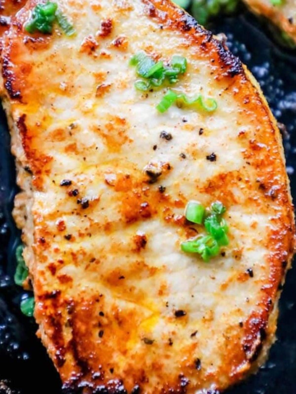 baked pork chop with minced chives in a pan