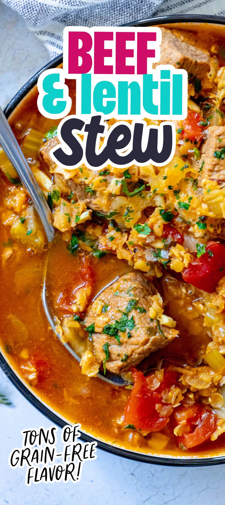 a piece of stew meat on a spoon, lentil and beef stew in a bowl in the background. 
