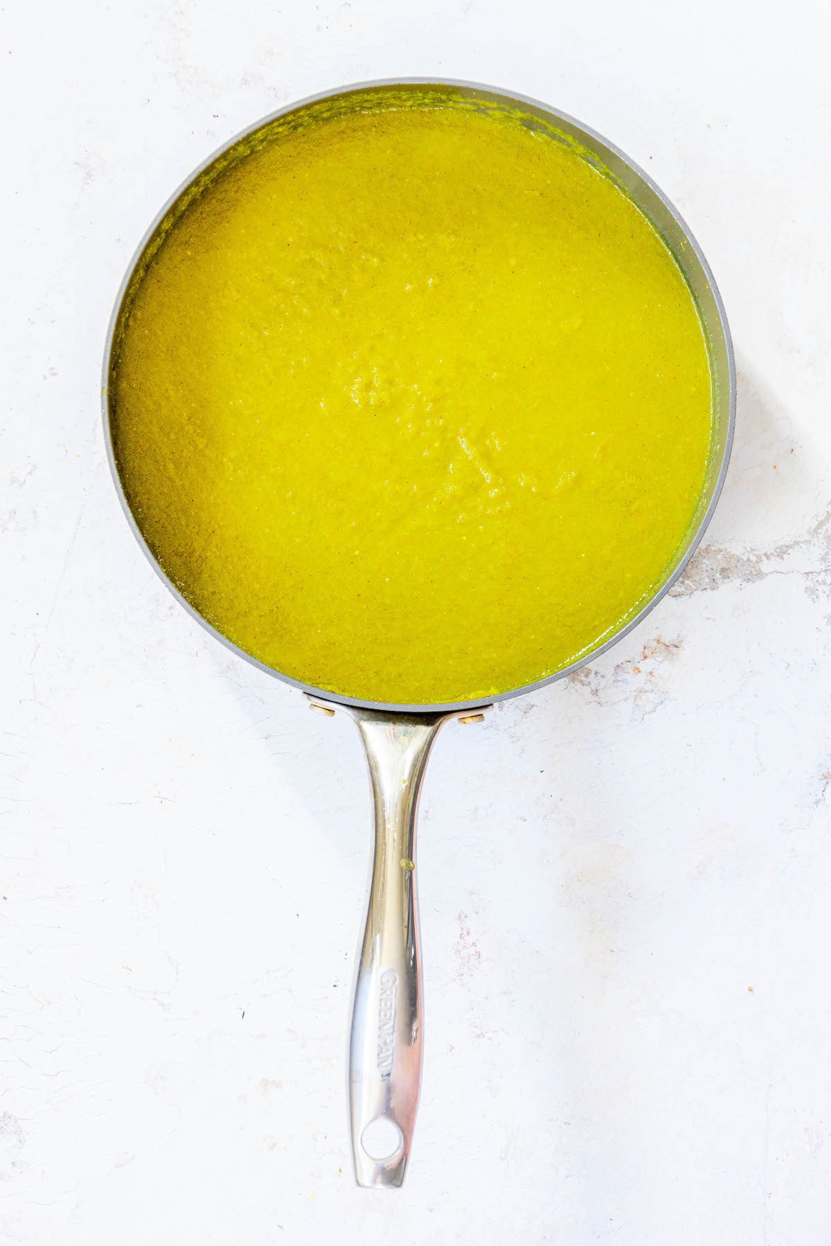 cooked posole green sauce in a pan