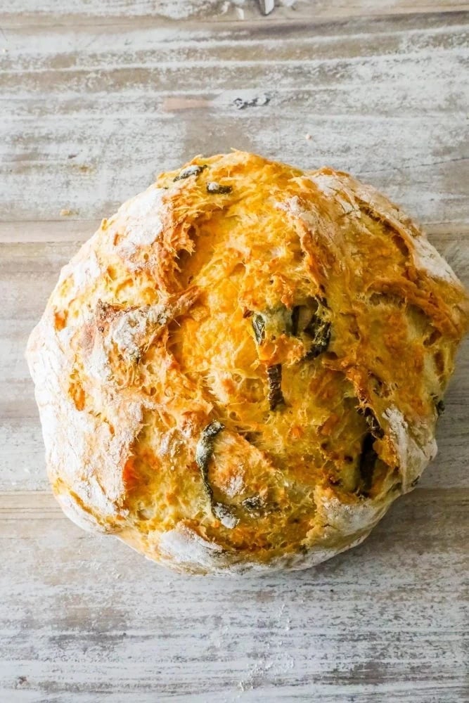 bread round with cheese and peppers baked in on a table