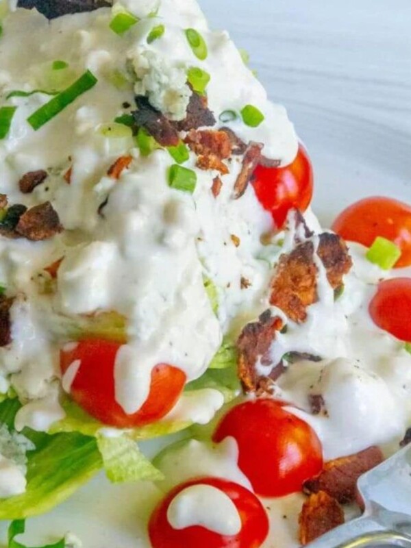 salad with green onions, tomatoes, bacon, and crumbled blue cheese dressing