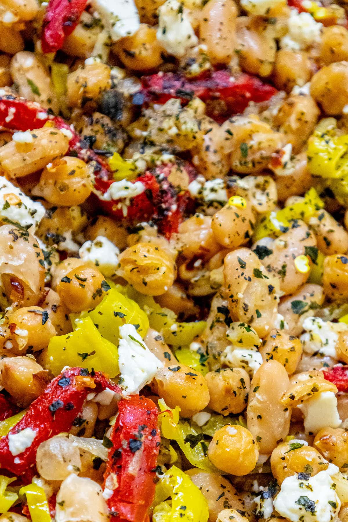 skillet with chickpeas, feta, herbs, red pepper strips, and onion