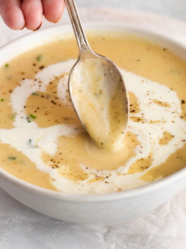 apple and cheddar soup in a bowl with a spoon