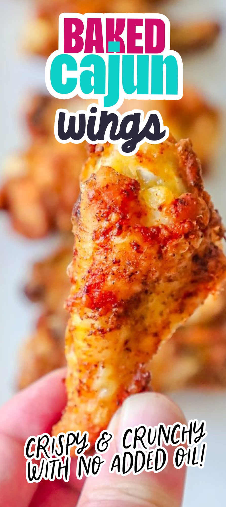 crispy baked chicken wing being held by a hand