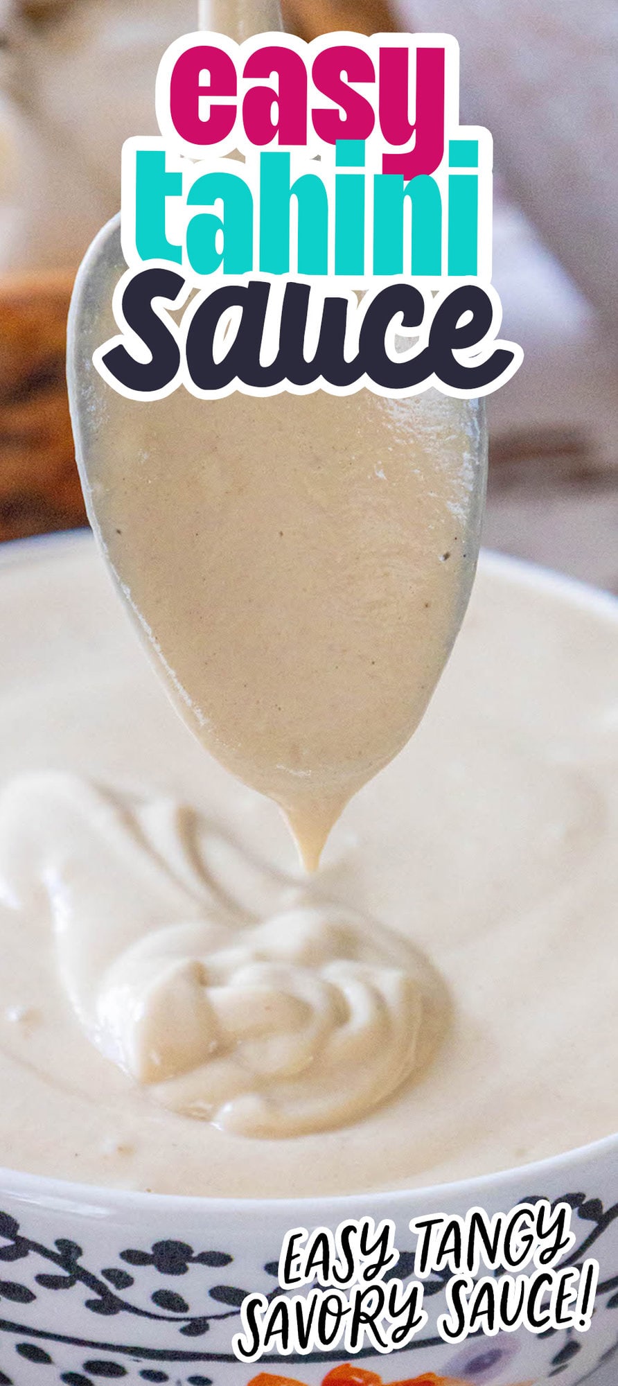 a spoon lifting tahini sauce over a bowl on a table