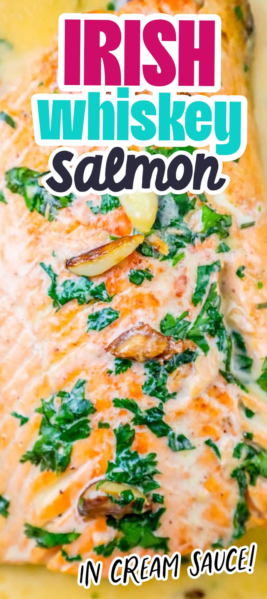 whiskey cream sauce salmon topped with chopped parsley and garlic cloves on top 