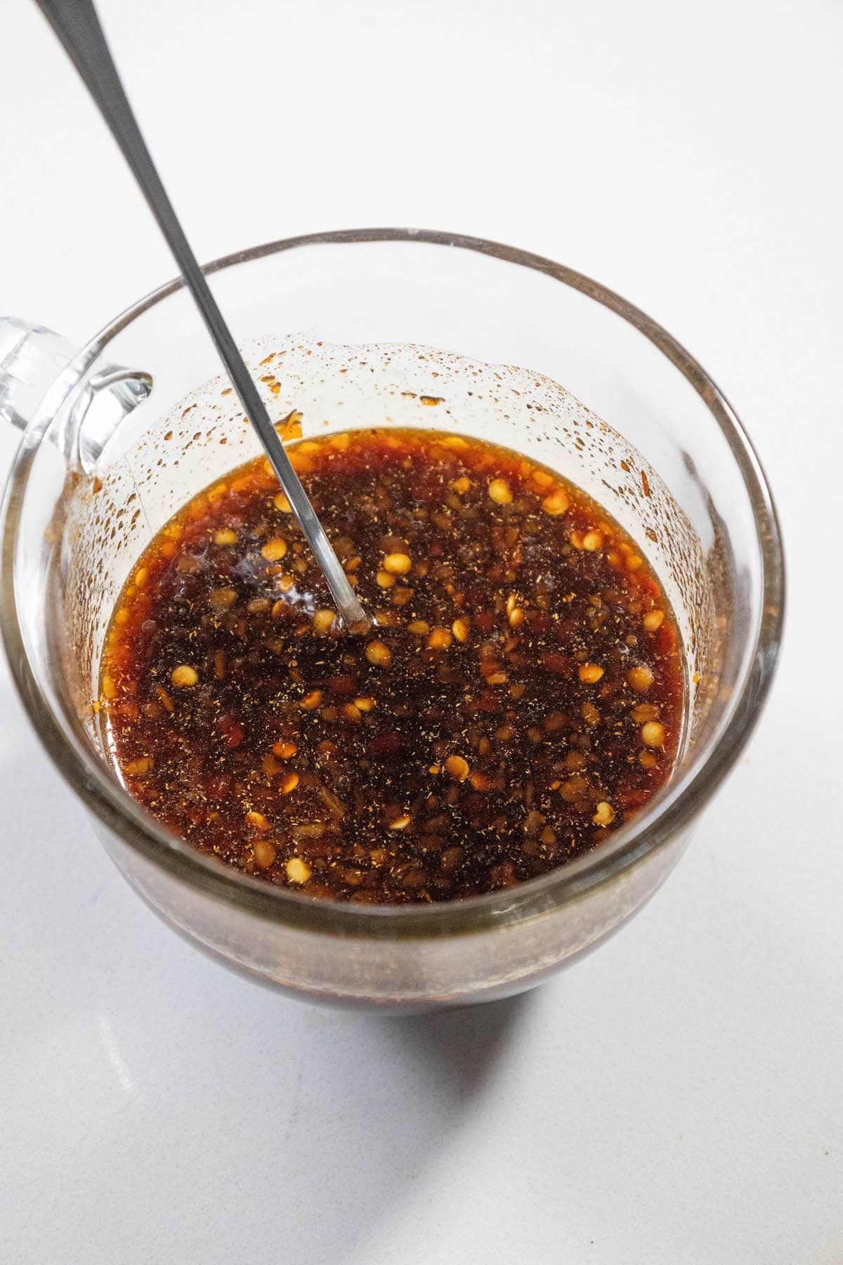 spicy sweet soy sauce ham glaze in a mixing bowl with a spoon