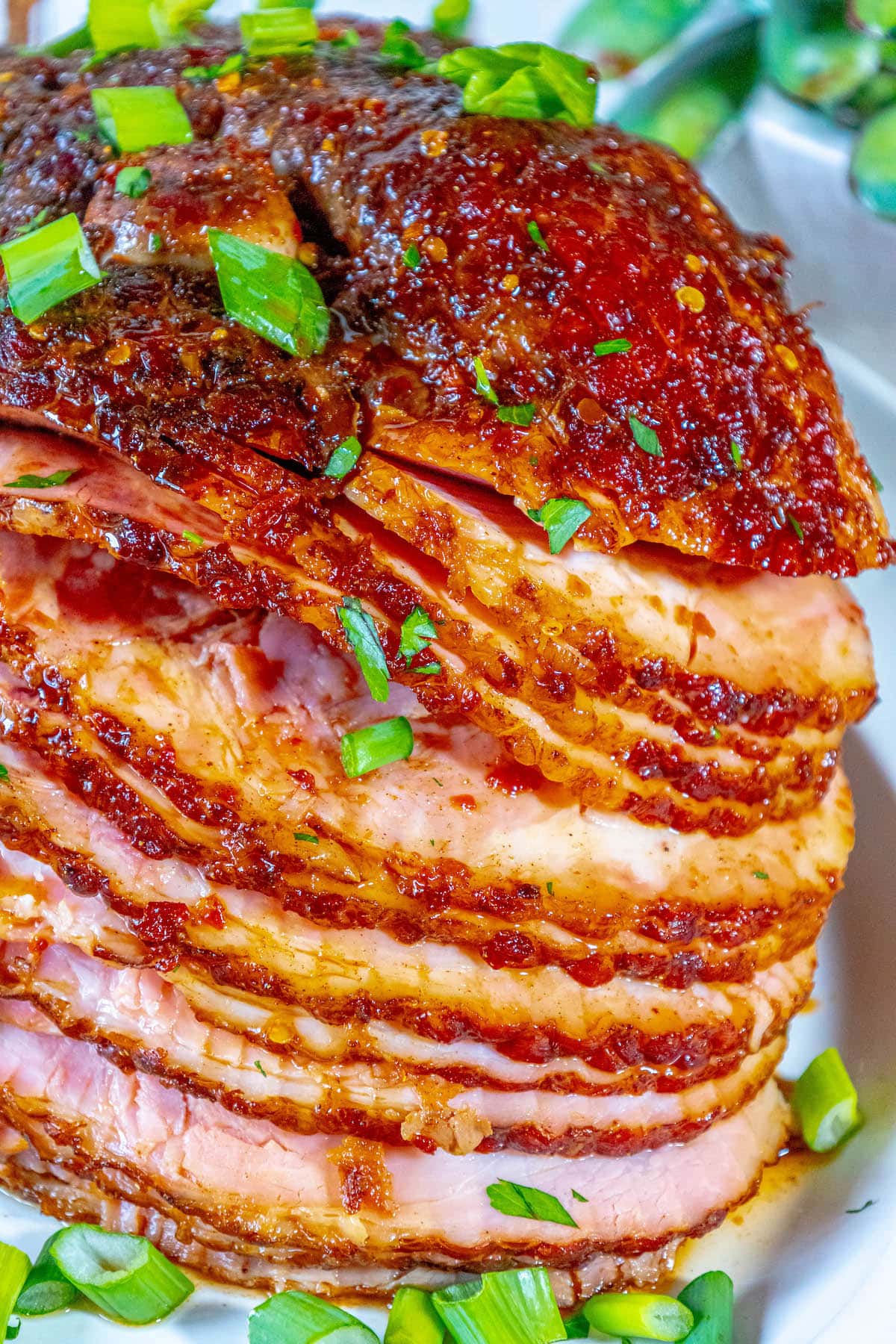 sliced spiral ham glazed with chili honey glaze and topped with green onions